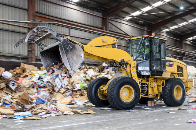 Bulldozer in paper recycling plant